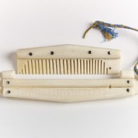 A bone comb with a case with a runic inscription saying 