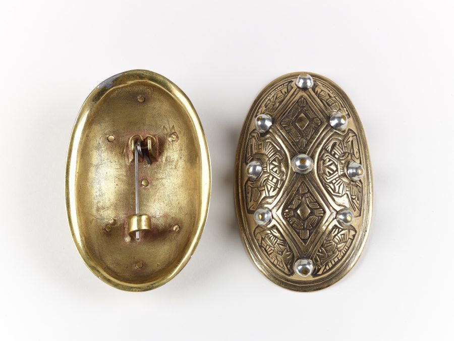 The front and reverse of a copper alloy oval brooch