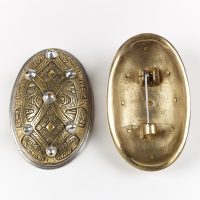The front and reverse of a copper alloy oval brooch