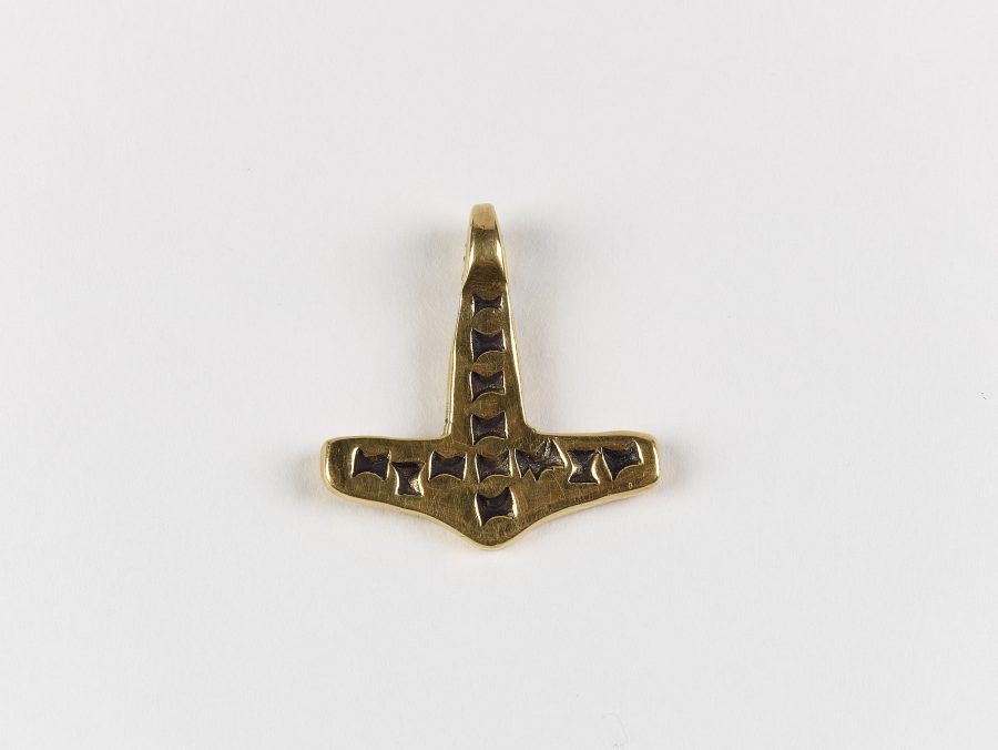 A gold hammer-shaped pendant commonly known as a Thor's hammer