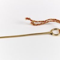 A reproduction copper alloy ring-headed pin