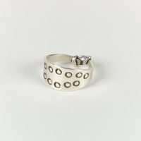 A reproduction stamped silver ring