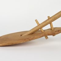 Detail of the blade of a reproduction wooden shovel showing how it attaches to the shaft