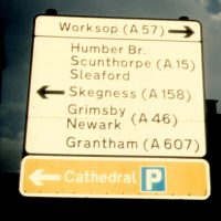 Road sign showing Grimsby, Scunthorpe, Skegness