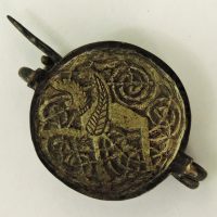 A silver gilt brooch depicting a griffin found in Repton, Derbyshire. (c) Derby Museum and Art Gallery